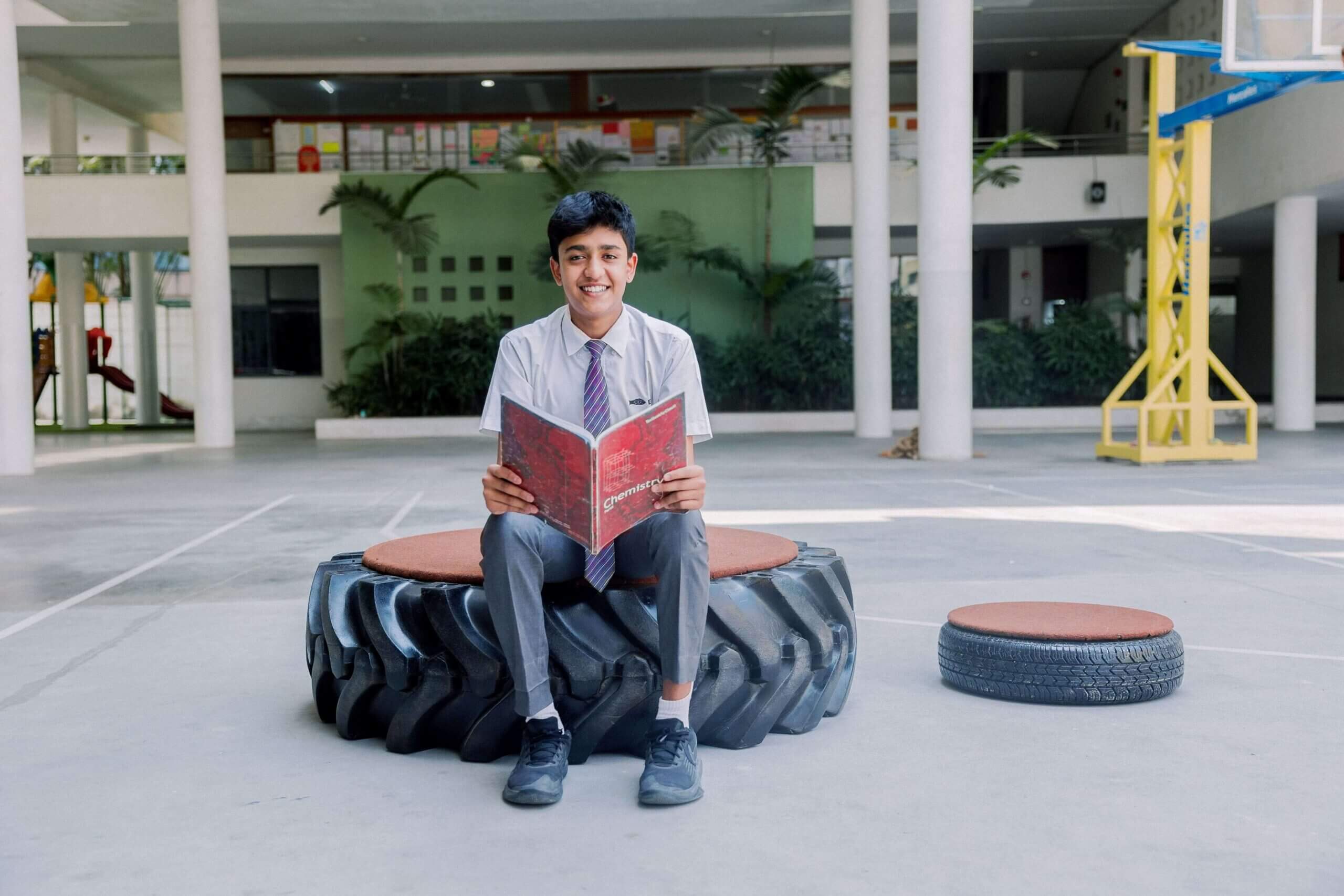 Ekya School Student sitting and reading the book inside the campus