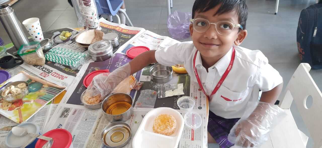best preschool in bangalore Ekya Student serving lunch