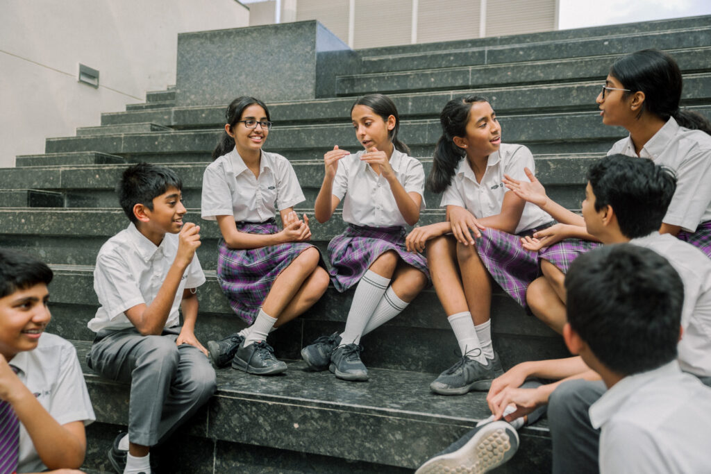 top schools in bangalore ekya school students sitting inside the campus